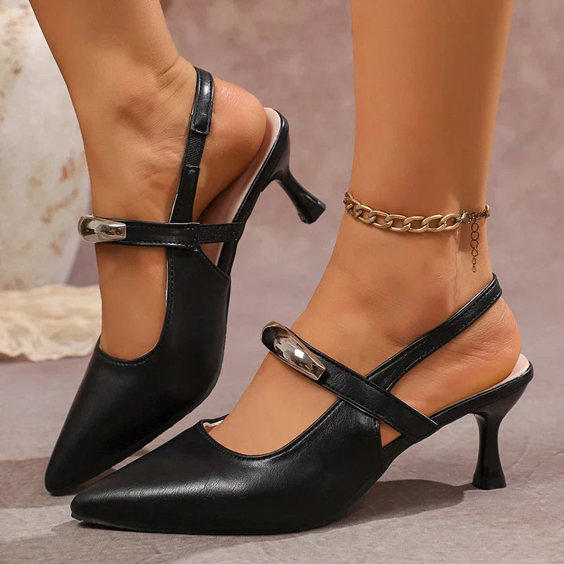 Pair of women's black pointed toe slingback heels on a white background.