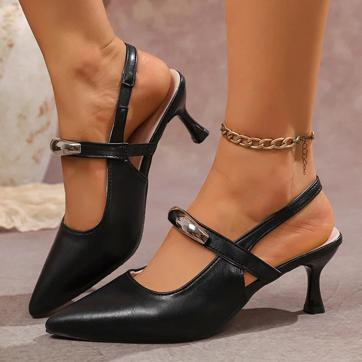 Pair of women's black pointed toe slingback heels on a white background.
