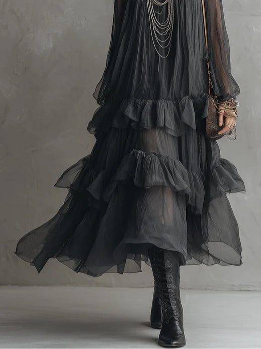 Elegant women's black tiered maxi dress, featuring a sheer fabric, V-neck, and ruffles. Ideal for evening wear.
