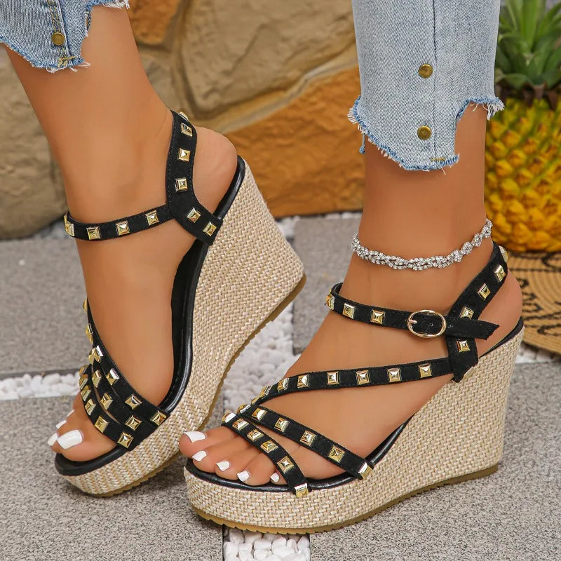 Close-up of studded detailing on women's black platform wedge sandal, fashion-forward design