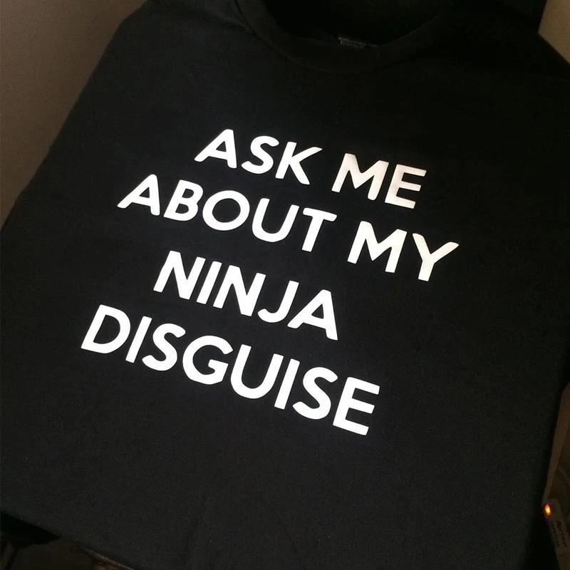 Casual grey t-shirt for men and women, showcasing a funny flip-up ninja graphic.