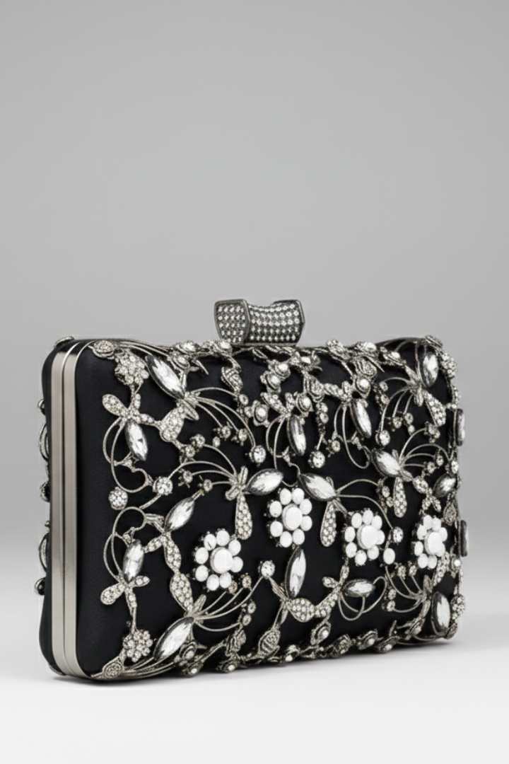 Black women's evening clutch with intricate gold embroidery and sparkling decorative stones for formal events.