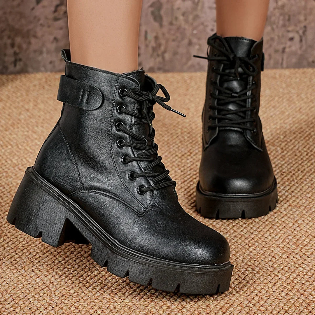 Stylish black lace-up ankle boots for women, featuring a chunky sole. Comfortable and trendy for winter fashion.