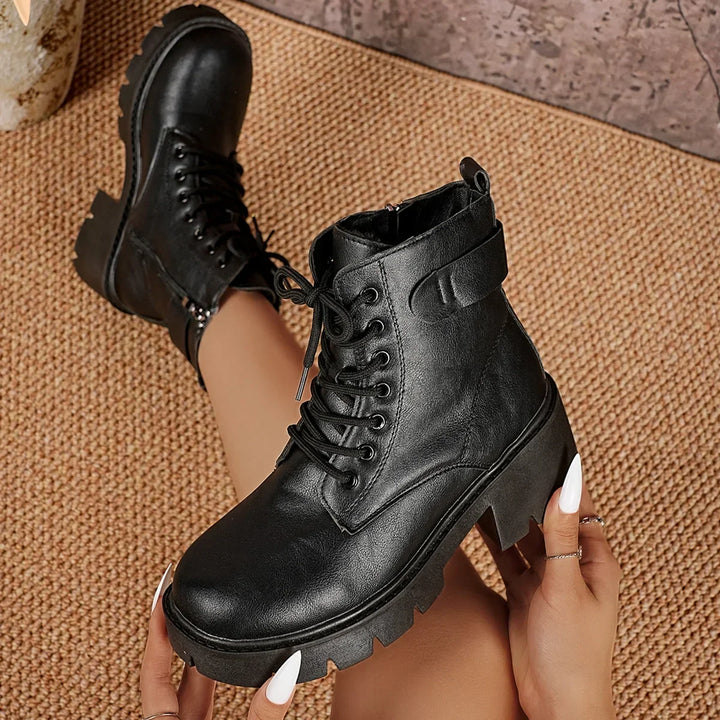 Women's black lace-up platform ankle boots with a chunky sole. Durable and chic, ideal for fall & winter outfits.