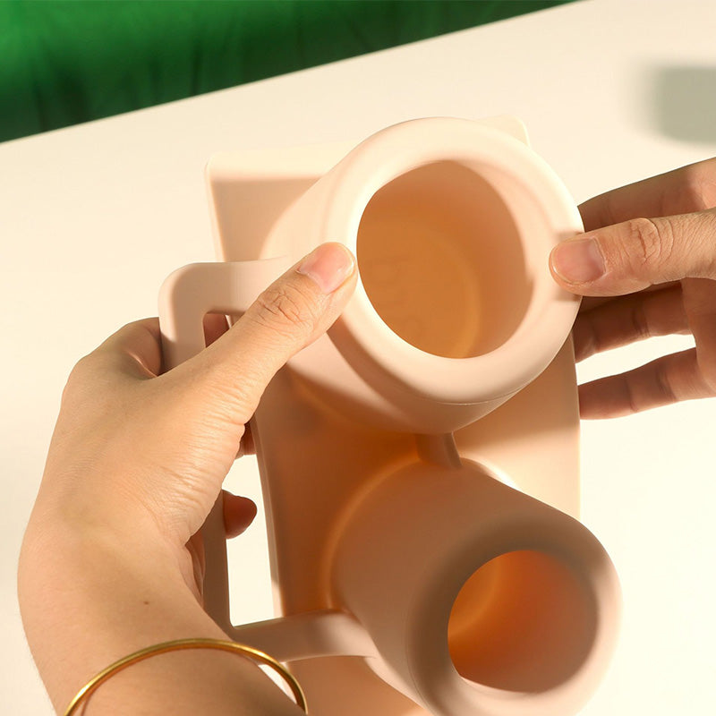 Silicone ice tray shown with water filled cubes before freezing, leakproof design.
