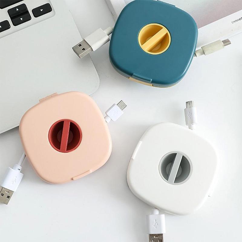 White universal cable winder & phone stand, showing grooves for multiple cables, an essential tech accessory.