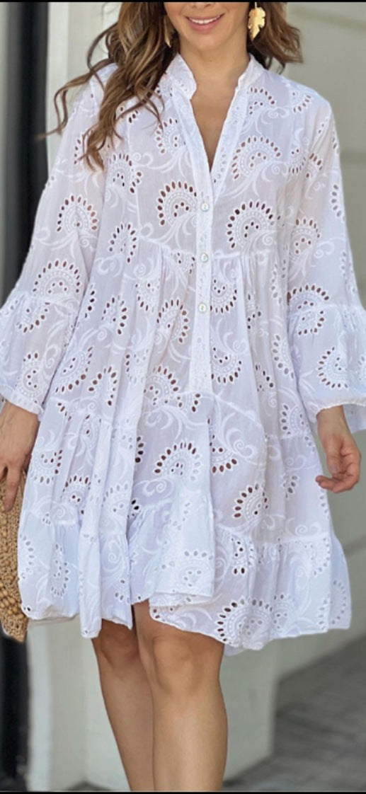 Women's embroidered tiered mini dress with intricate bohemian detail. A-line silhouette, perfect party dress.