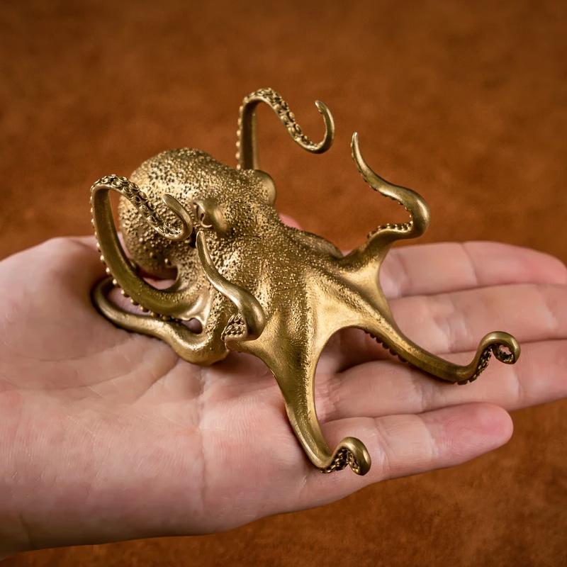 Detailed brass octopus sculpture, functions as a phone stand & desk ornament