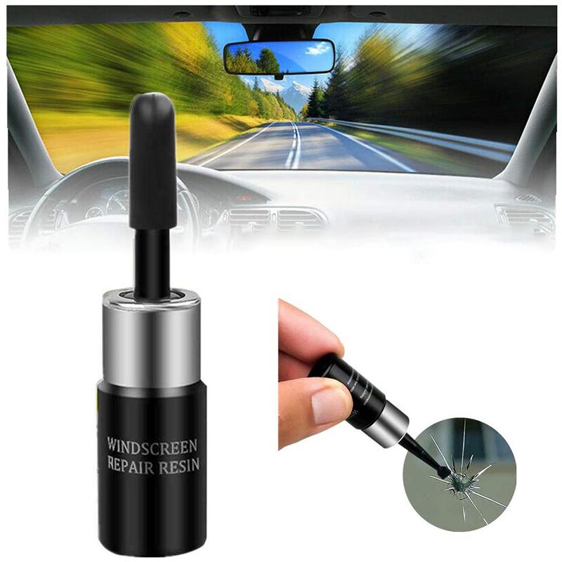 Windshield repair fluid and tools laid out, essential for effective car crack filler application