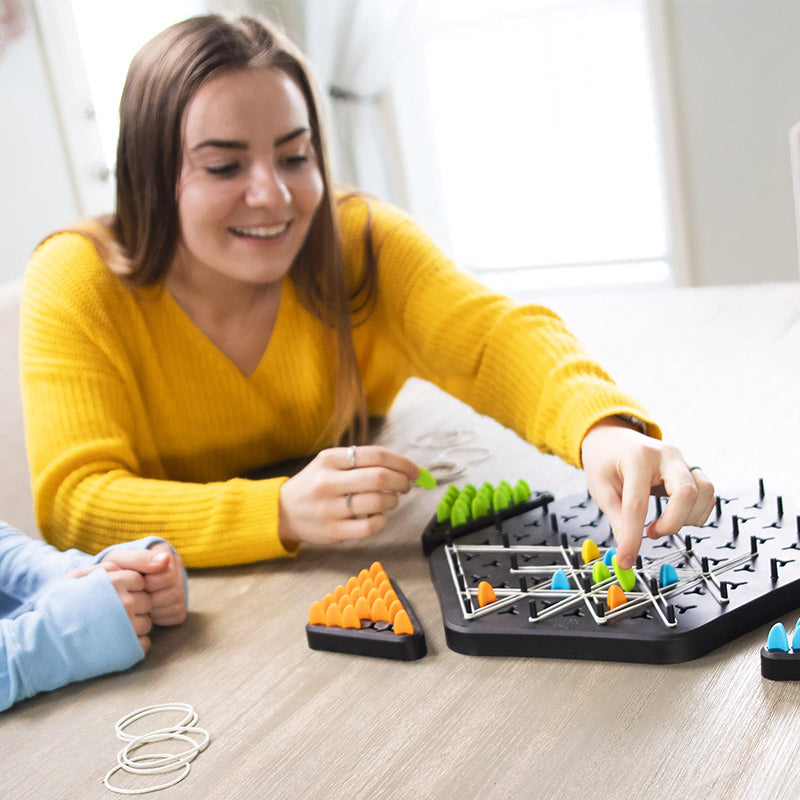Two players engaged in a strategic move during a game of Chain Triangle, the family board game