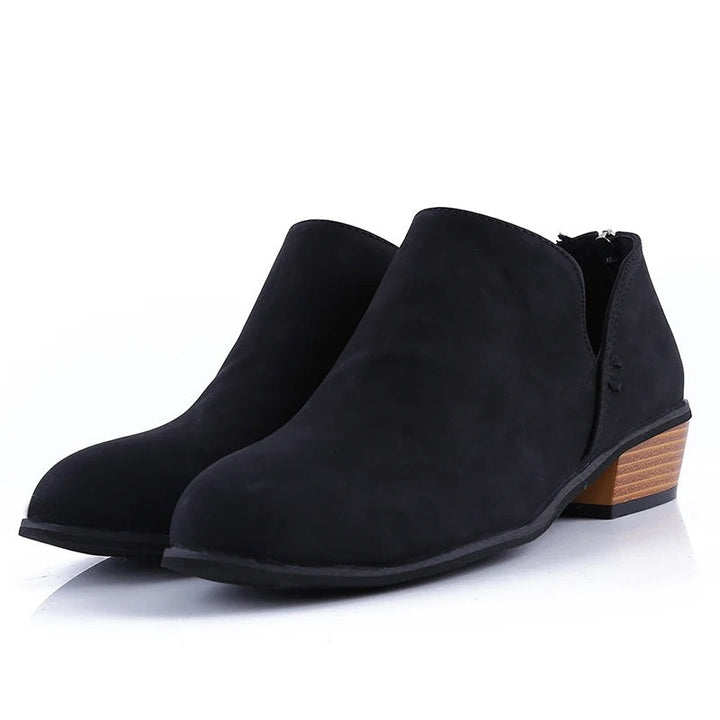 Elegant women's fall ankle boots with a sturdy low block heel and distinctive back zip detail.