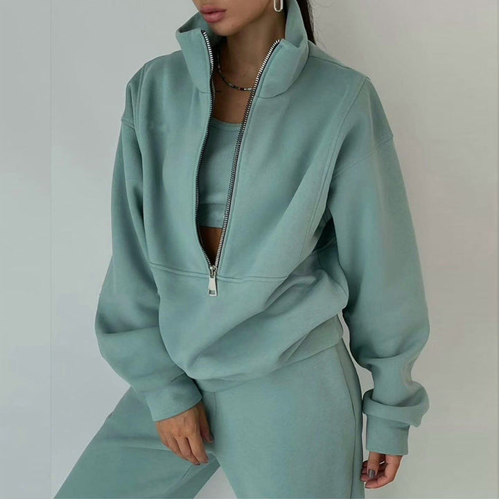 Detail of women's half-zip pullover & high-waisted joggers. Chic & comfortable two-piece athleisure set.
