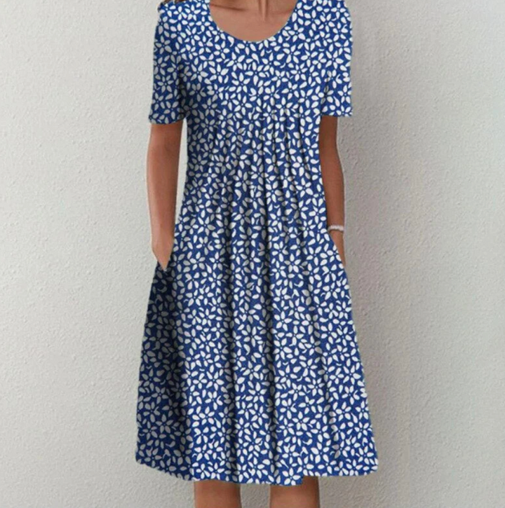Versatile women's fashion A-line summer dress with chic print & pleats, suitable for casual or bohemian style.