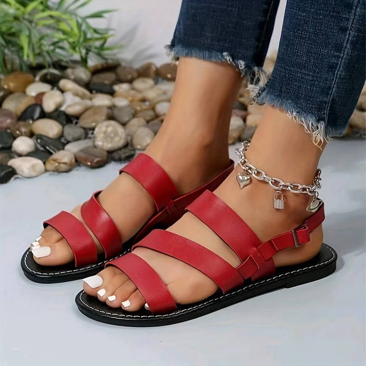 Comfortable women's three-strap open-toe flat sandals, ideal for warm weather casual and everyday wear.