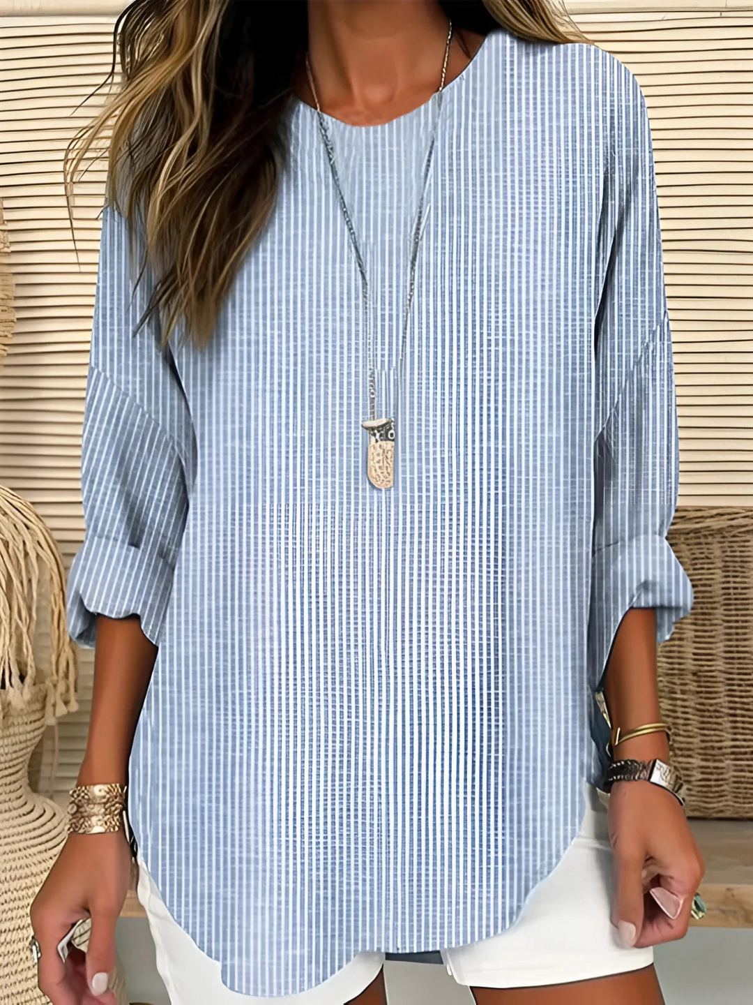 Chic women's vertical stripe blouse with long sleeves and round neck, perfect for work or casual everyday wear.