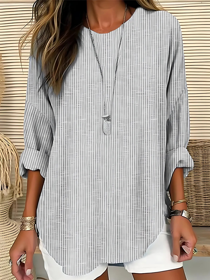 Stylish women's vertical stripe long sleeve blouse with a comfortable round neck for modern casual fashion.