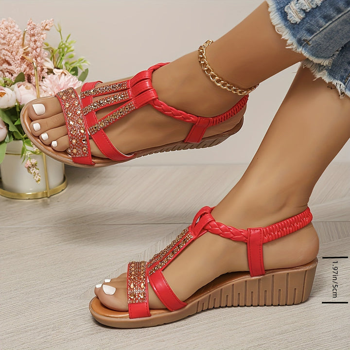 Elegant women's flat woven sandals with sparkling rhinestones, perfect for sophisticated summer style.