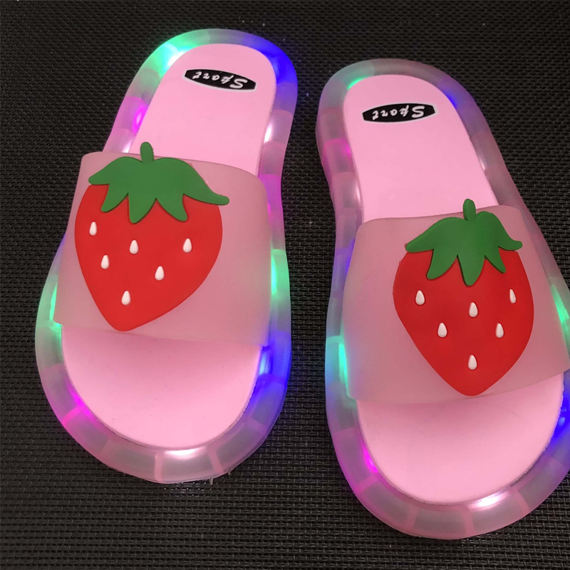 Children's anti-slip LED light-up summer slippers in orange, great for active play.