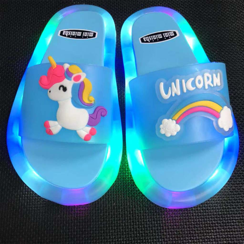 Happy child jumping in their new pink LED light-up summer slides, enjoying the lights.