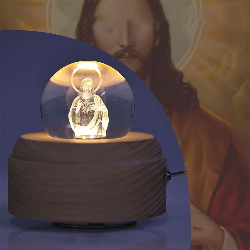 Hand holding Christian Faith Crystal Ball, showcasing its radiant glow, religious collectible