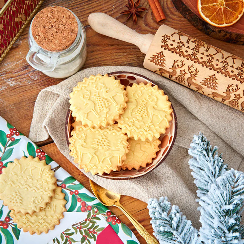Christmas patterned wooden rolling pin for holiday baking, embossing cookies with festive designs.