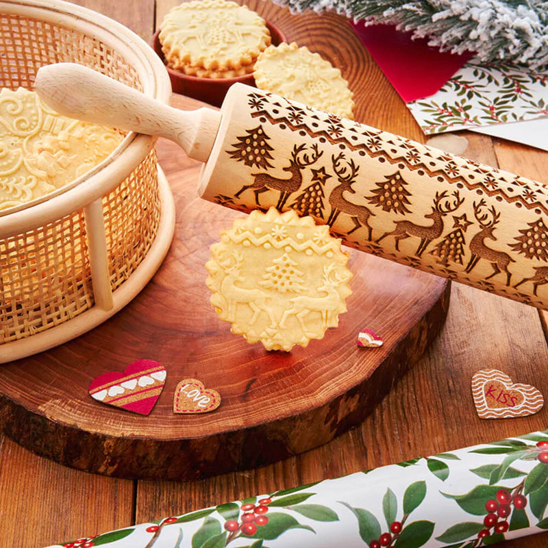 Wooden rolling pin with intricate Christmas patterns, ideal for festive cookie and pastry making.