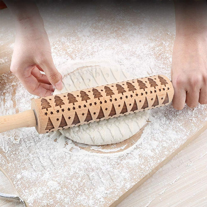 Festive wooden rolling pin showcasing various Christmas patterns for unique cookies.