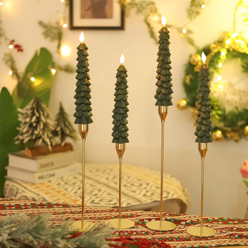 Close-up of a white LED Christmas candle clipped onto a green Christmas tree branch