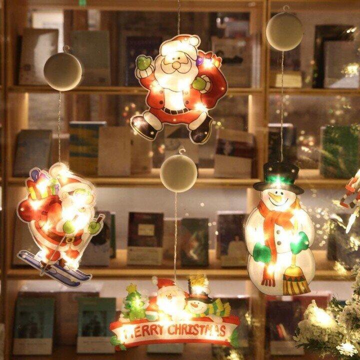 Close-up of a festive Christmas Window Suction Cup LED Light, intricate snowflake design by window pane