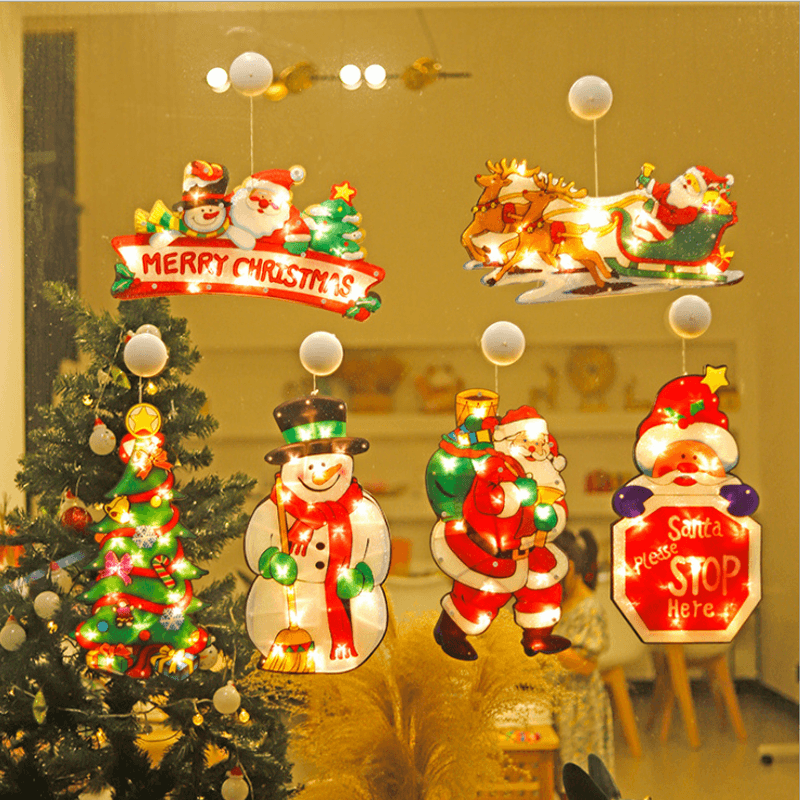 Christmas LED light glowing, attached to window by suction cup, depicting a reindeer silhouette, indoor view