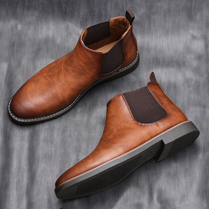 Modern grey men's Chelsea boots, sleek design, comfortable slip-on footwear for any occasion.