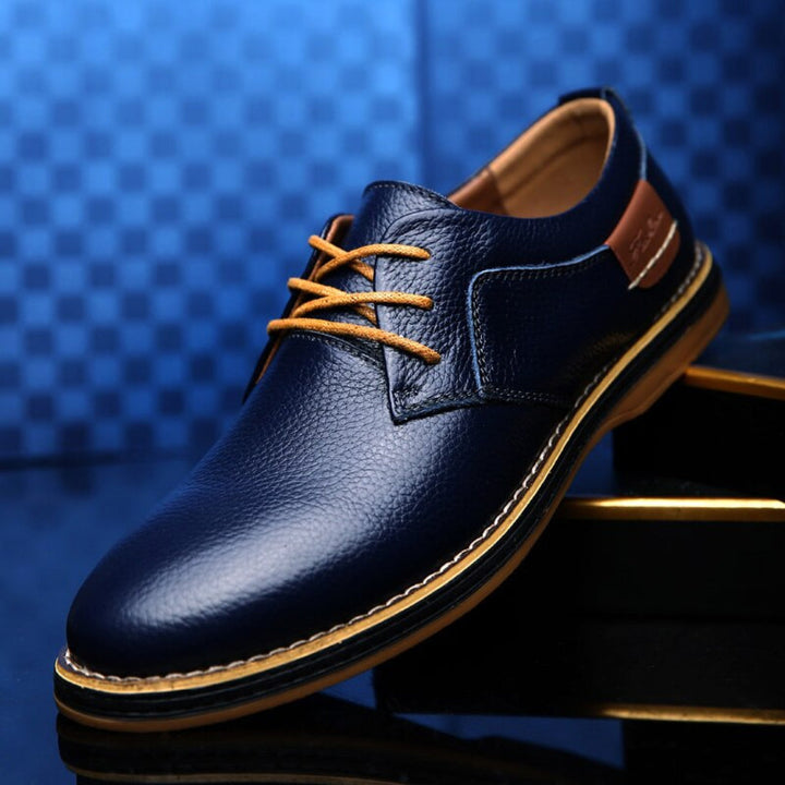 Stylish men's brown leather Oxford shoes. Versatile for casual & formal wear, offering sophisticated style & comfort.
