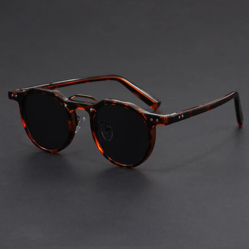 Vintage-inspired round sunglasses, unisex design, offering essential UV400 protection and style.
