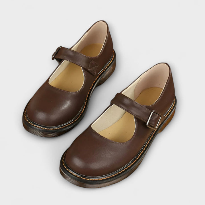 Classic Women's Mary Jane flats with a comfortable rounded toe and adjustable buckle strap, perfect for everyday wear.