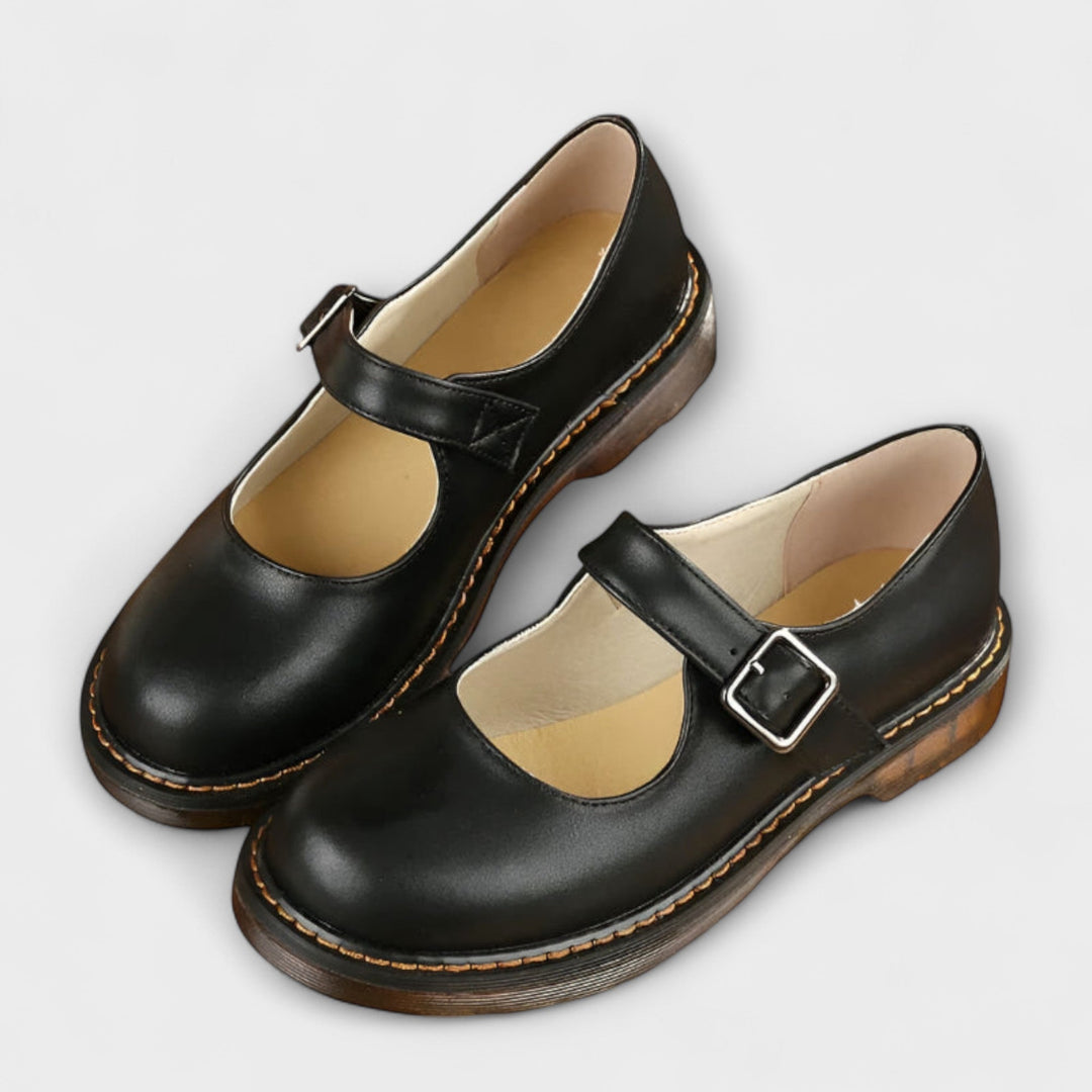Stylish black Women's Mary Jane shoes, featuring a timeless buckle strap & rounded toe for casual or work fashion.