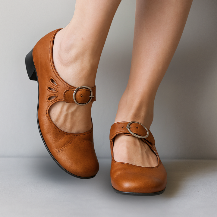 Stylish ladies' Mary Jane shoes featuring a secure buckle strap, round toe, & comfortable low block heel.