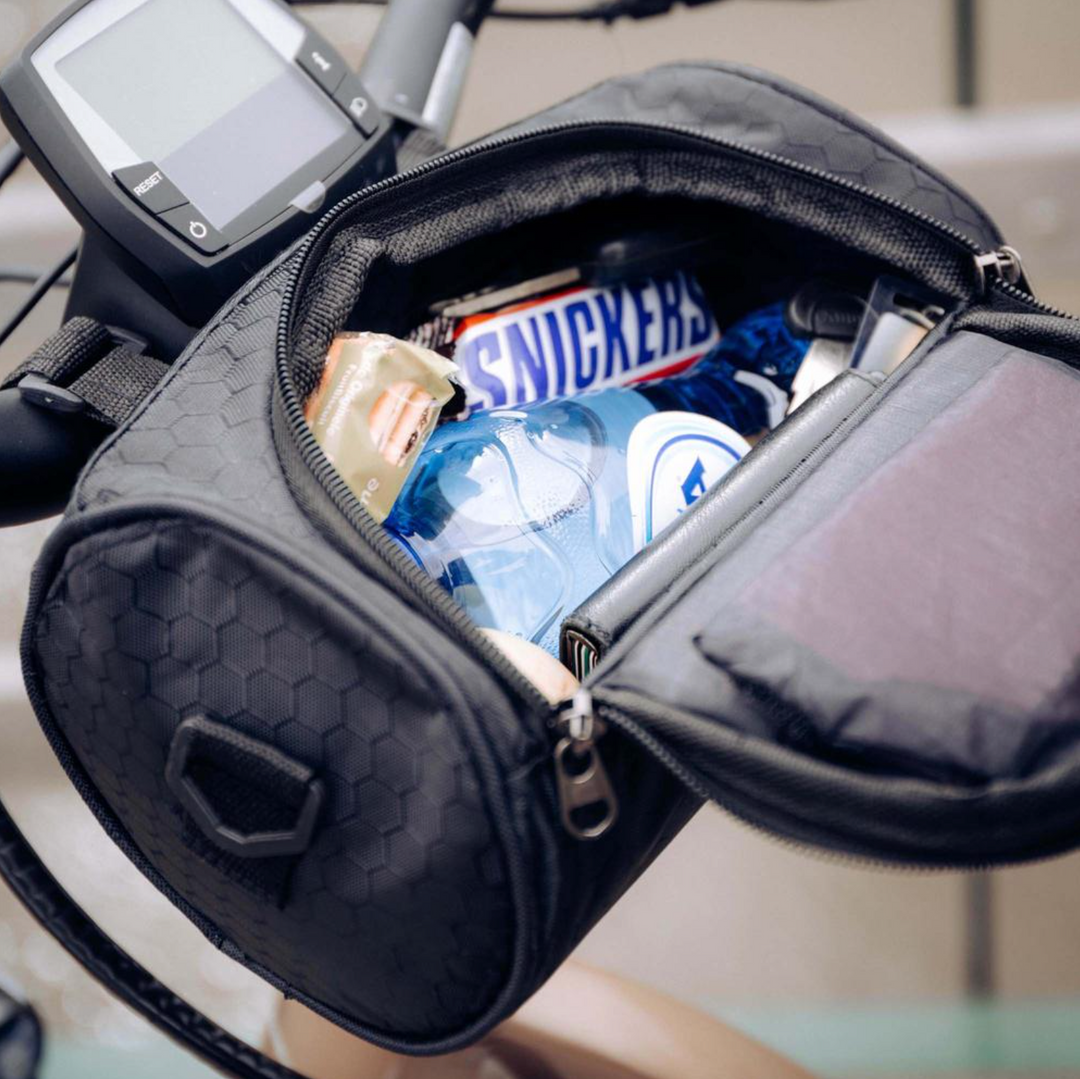 Unisex handlebar bag attached to a bicycle, perfect for holding phone & essentials on rides.