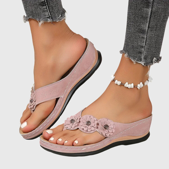 Pair of lightweight women's flip flops with superior foot support, ideal for beachwear & daily comfort.