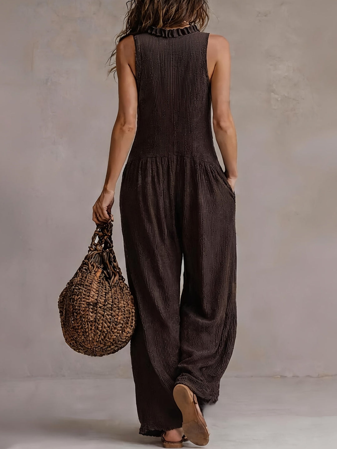 Womens coffee brown wide leg jumpsuit with ruffle V-neck, smocked waist, and button front. Trendy casual fashion.