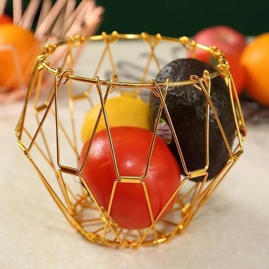 Silver collapsible stainless steel fruit basket, a sleek and space-saving kitchen storage solution.