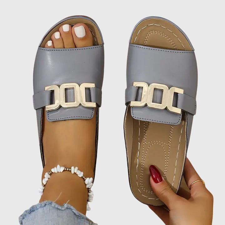 Versatile women's comfy buckle sandals with gold details. Perfect open-toe flat for summer casual or dressy looks.