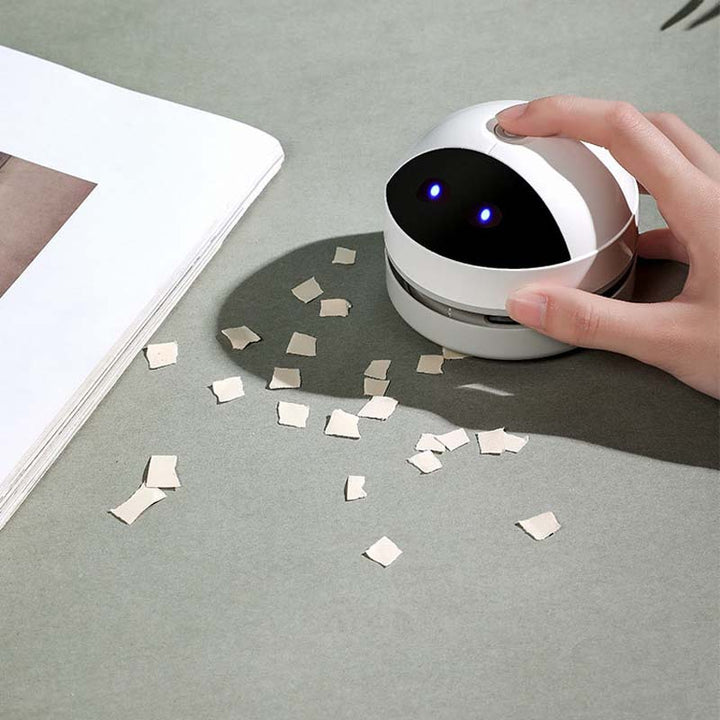 Side view of the white portable desktop cleaner, emphasizing its sleek, space-saving design.