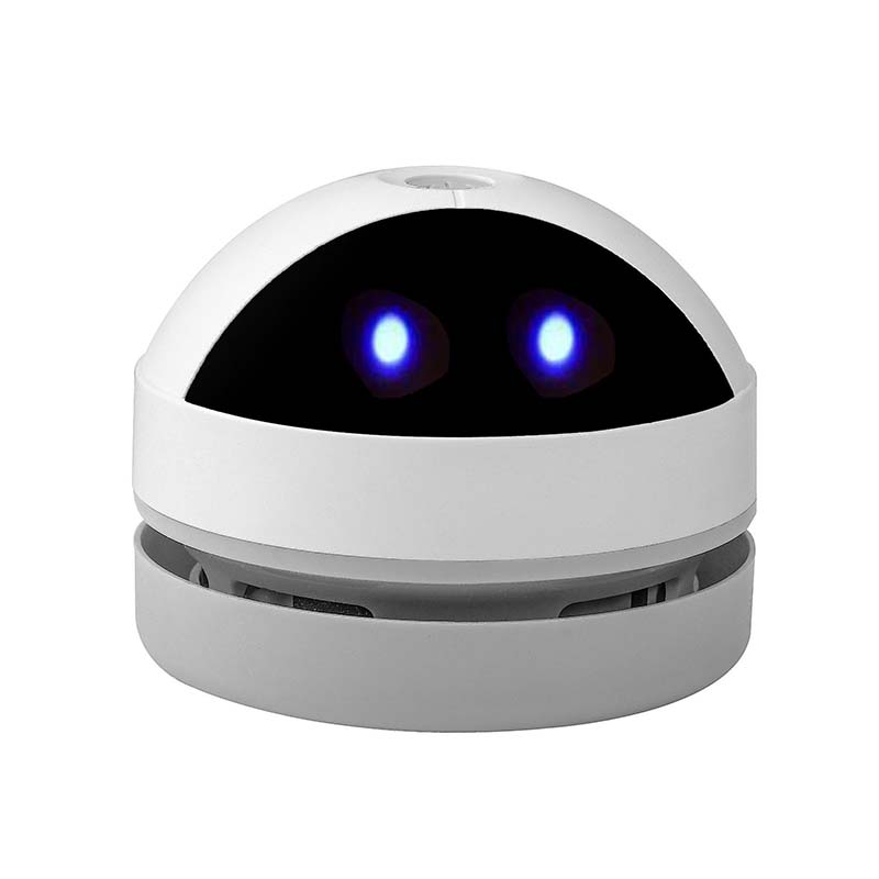 A white compact cleaner shown in a home office setting, maintaining a tidy workspace.