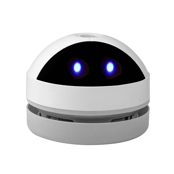 A white compact cleaner shown in a home office setting, maintaining a tidy workspace.