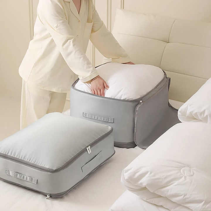 Compression bag for bedding, partially zipped to show the space-saving functionality for duvets
