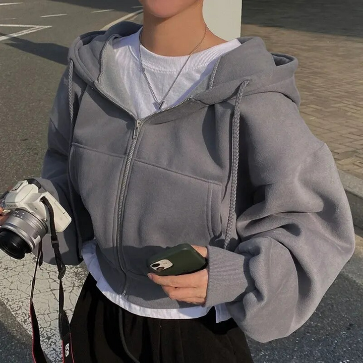 Stylish cropped zip-up hoodie for women, designed for comfort and warmth in winter fashion.