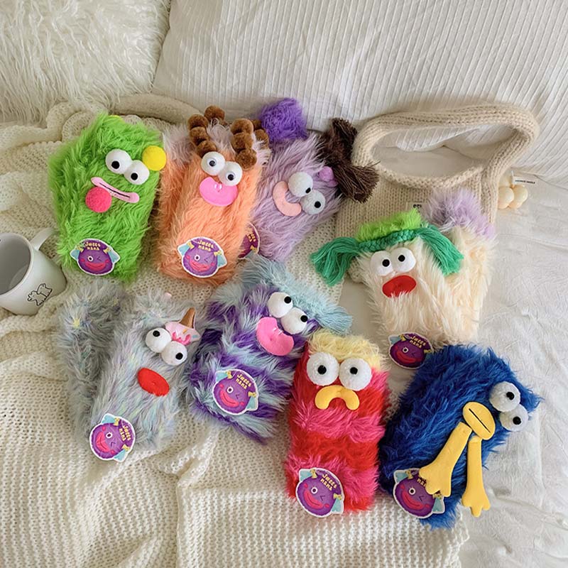 Colorful women's fluffy monster socks, whimsical cartoon design, warm winter apparel.