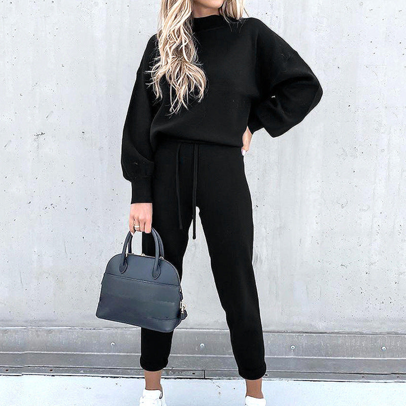 Stylish women's athleisure two-piece set, featuring a crewneck sweatshirt and cuffed joggers in a solid color.