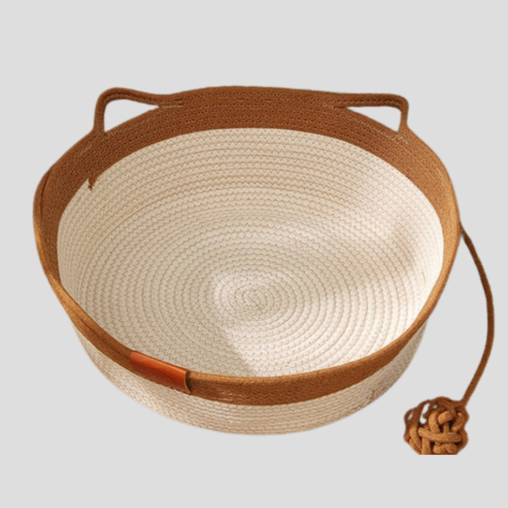 Gray woven cotton rope cat bed provides a cozy lounge spot. Comfortable pet furniture for indoor cat relaxation.
