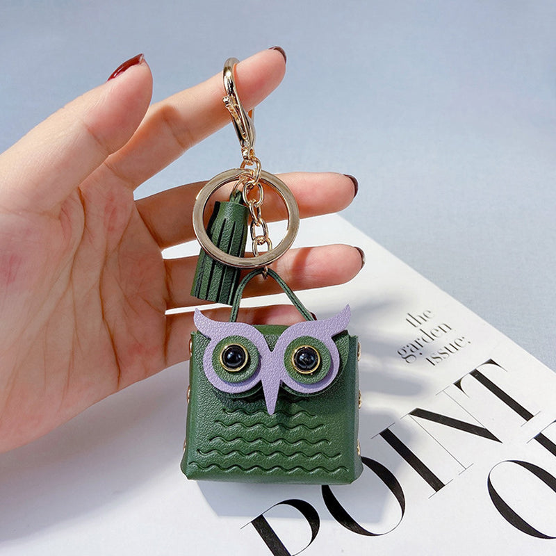 Cute mini handbag keychain alongside a smartphone, showing its compact size and versatility